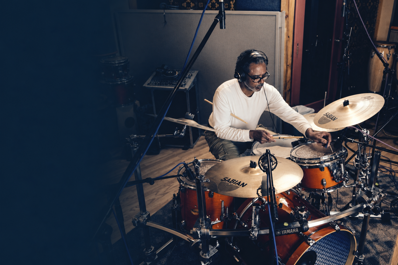Harold Brown playing drums in a recording studio.